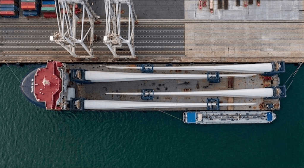 A vessel loaded with wind turbine blades at port